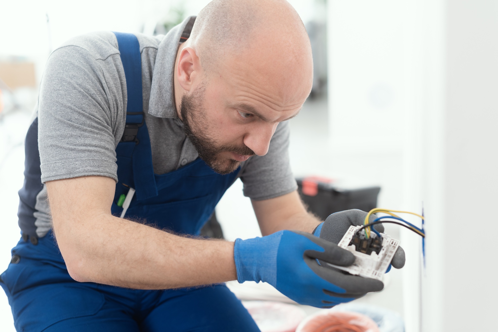 Professional electrician installing a wall socket